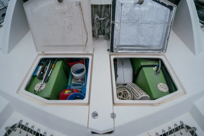 Slide: The Image of Open storage compartments on a 2011 Leopard 38 catamaran, revealing equipment and supplies. - 156