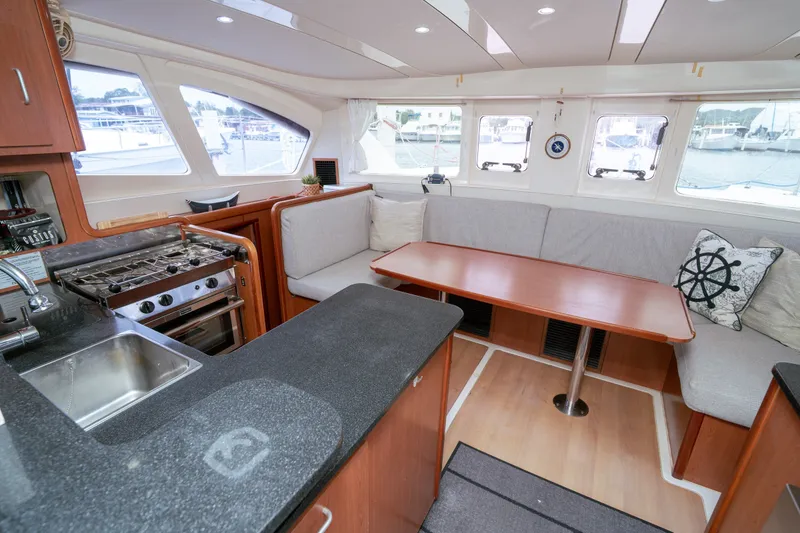 Slide: The Image of Interior of 2011 Leopard 38 catamaran with kitchen and cozy seating area. - 107