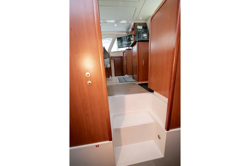 Slide: The Image of Interior view of 2011 Leopard 38 yacht, featuring wooden cabinetry and steps. - 99