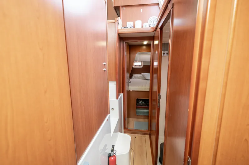 Slide: The Image of Interior of 2011 Leopard 38 yacht, featuring wooden cabinetry and a cozy sleeping area. - 97