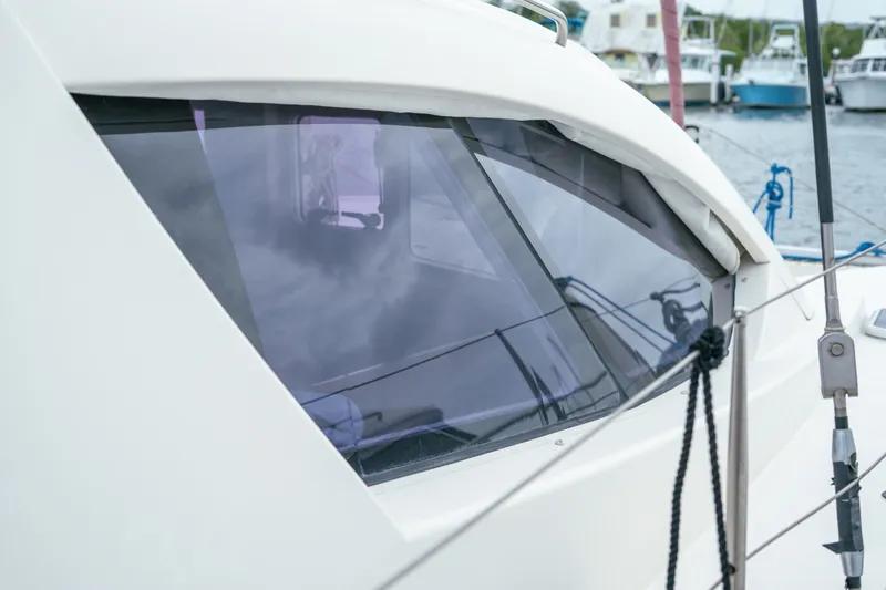 Slide: The Image of Close-up of a 2011 Leopard 38 yacht window with marina background. - 74