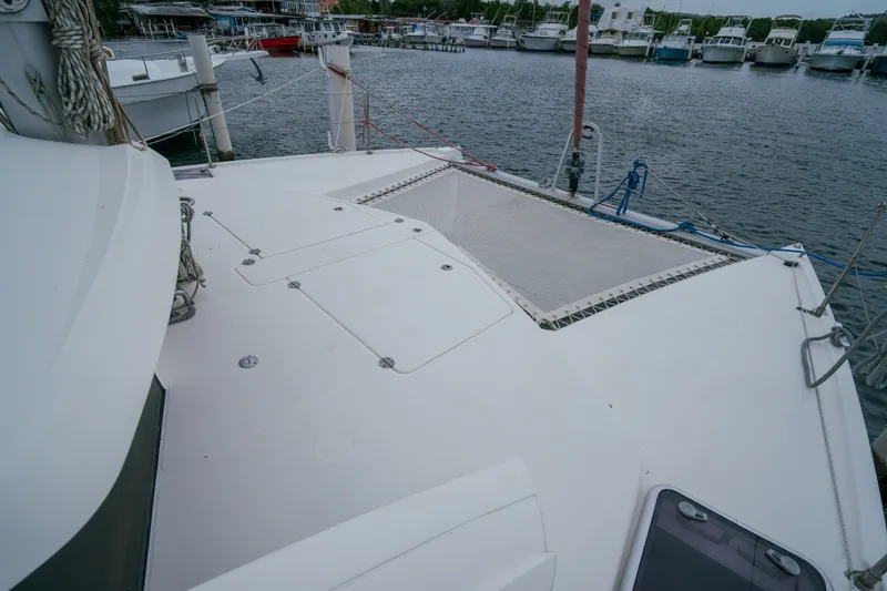 Slide: The Image of 2011 Leopard 38 catamaran deck with netting, docked in a marina. - 38