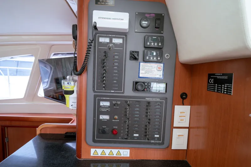 Slide: The Image of Electrical control panel on a 2011 Leopard 38 catamaran, featuring various switches and gauges. - 135