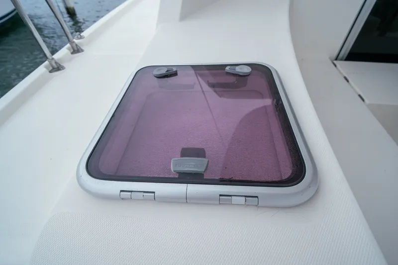 Slide: The Image of Hatch on 2011 Leopard 38 yacht deck, featuring tinted cover and secure latches. - 55