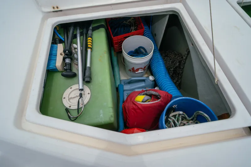 Slide: The Image of Storage compartment on a 2011 Leopard 38 boat, containing tools, ropes, and equipment. - 158