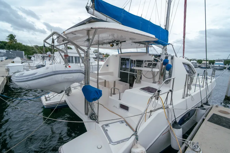 Slide: The Image of 2011 Leopard 38 catamaran docked with inflatable dinghy and blue sail cover. - 19