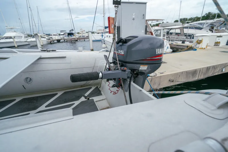 Slide: The Image of Inflatable boat with Yamaha 15 outboard motor docked at marina, Leopard 38, 2011 model. - 26