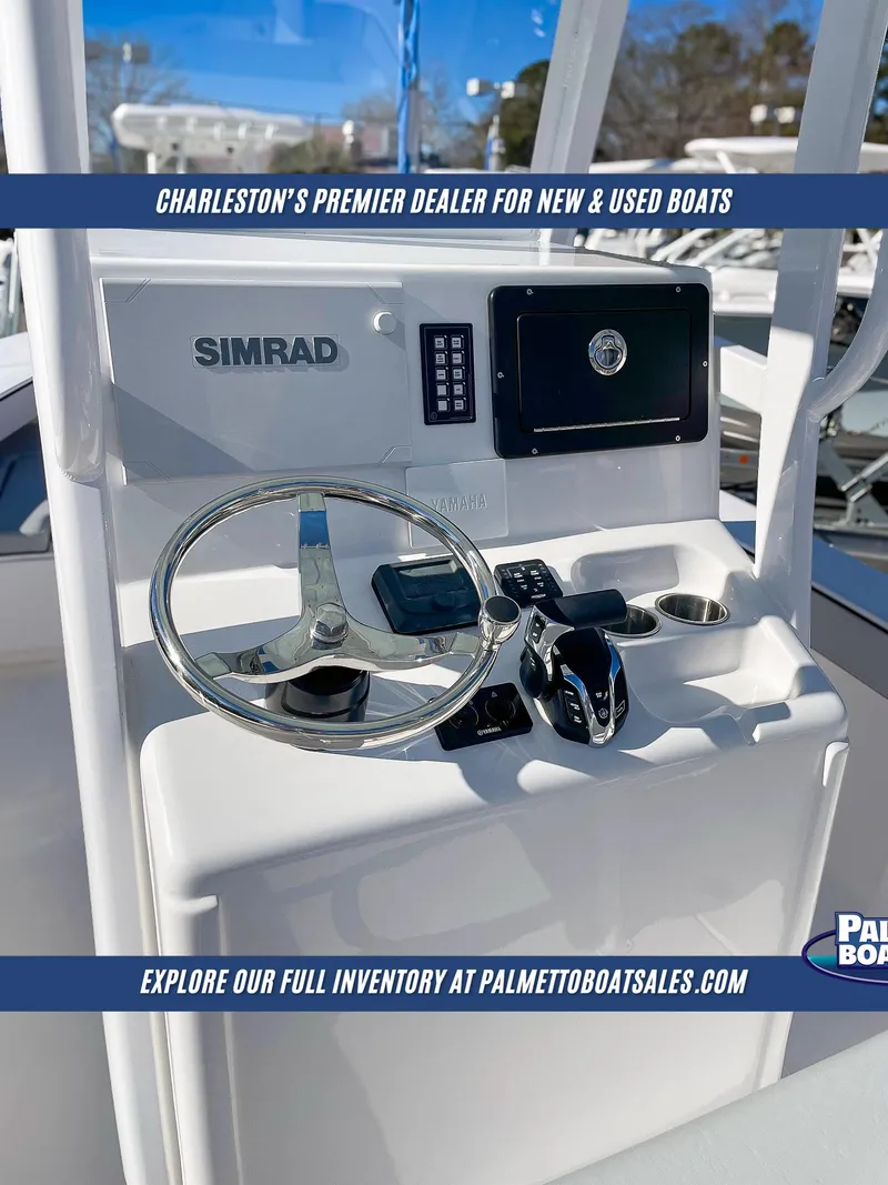 Slide: The Image of Delta Boatworks 245, 2025 model, steering console with Simrad electronics, showcased by Palmetto Boat Sales. - 7