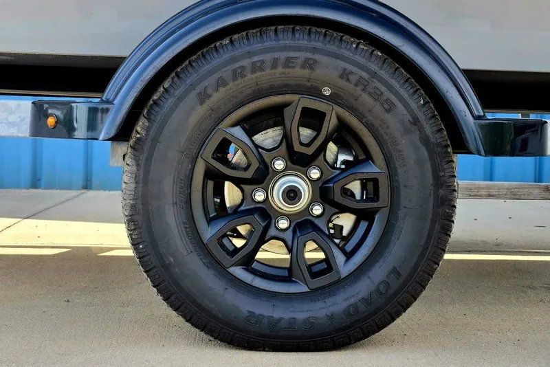 Slide: The Image of 2027 Tracker Bass Tracker Classic CC trailer wheel with Karrier KR35 tire. - 16