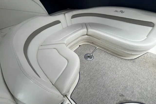 Slide: The Image of 2004 Sea Ray Sundancer 320 interior with white leather seating and carpeted floor. - 9