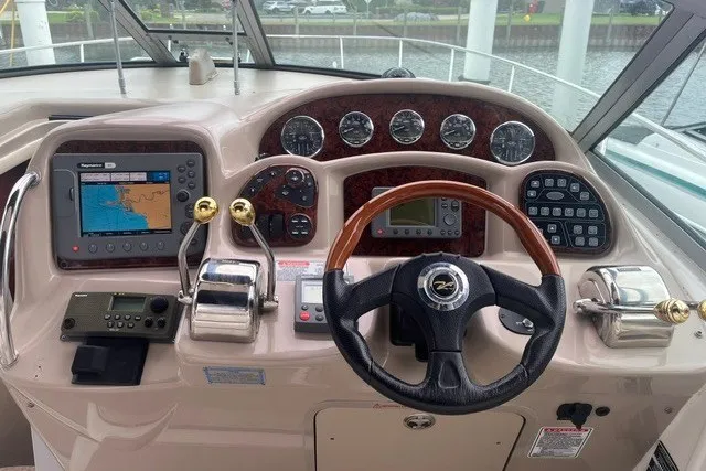 Slide: The Image of Control panel of a 2004 Sea Ray Sundancer 320 with navigation and steering instruments. - 10