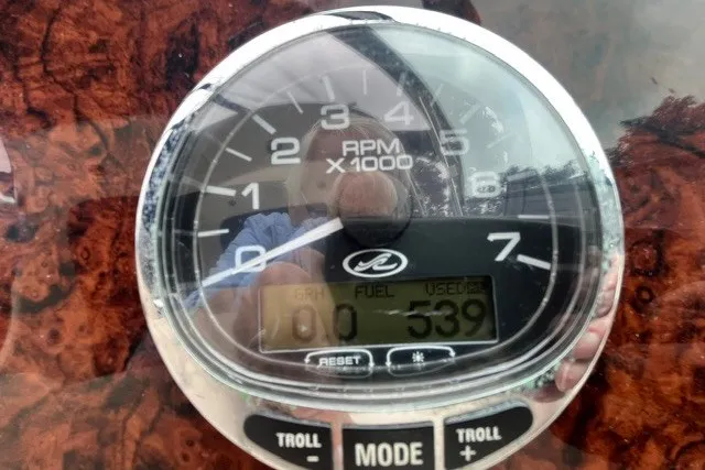 Slide: The Image of Close-up of a tachometer with wood grain background, displaying 539 engine hours. - 15