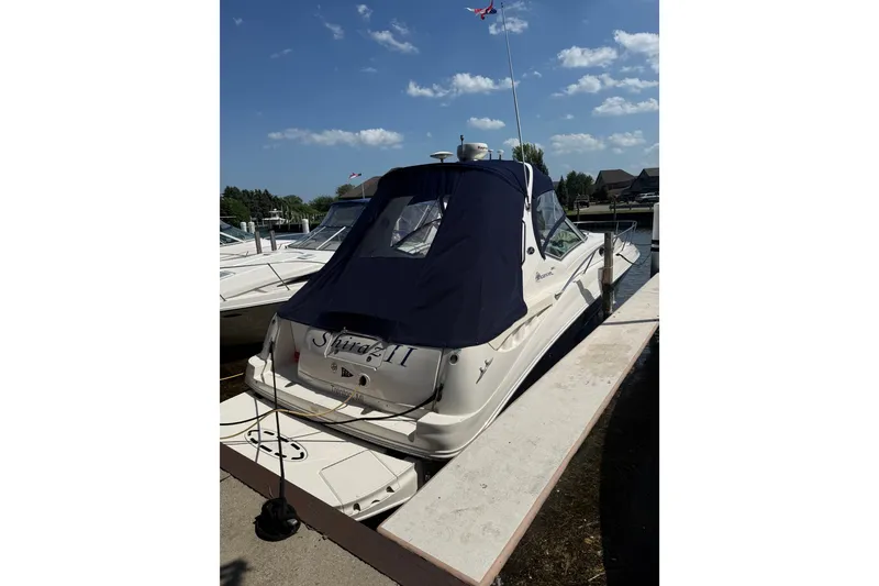 Slide: The Image of 2004 Sea Ray Sundancer 320 docked under a clear blue sky. - 2