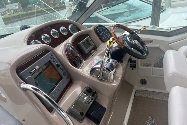 Slide: The Image of 2004 Sea Ray Sundancer 320 helm with navigation instruments and steering wheel. - 12