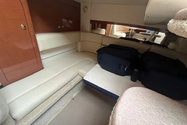 Slide: The Image of Interior of 2004 Sea Ray Sundancer 320 yacht with beige seating and luggage. - 29