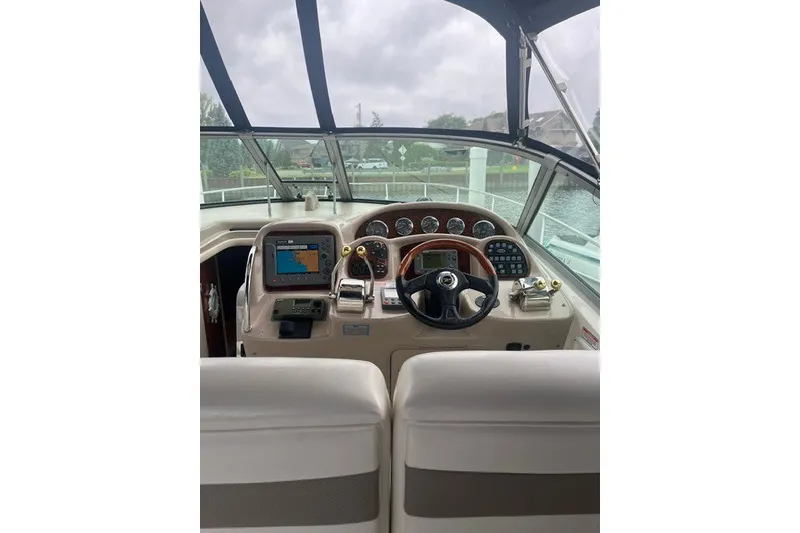 Slide: The Image of Cockpit of 2004 Sea Ray Sundancer 320 with navigation equipment and steering wheel. - 11