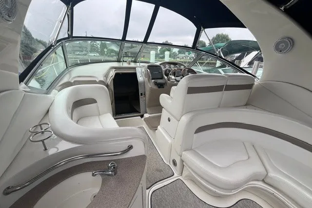 Slide: The Image of 2004 Sea Ray Sundancer 320 interior with plush seating and modern dashboard. - 5