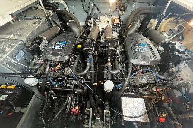 Slide: The Image of Engine room of a 2004 Sea Ray Sundancer 320, showcasing twin engines and mechanical components. - 31
