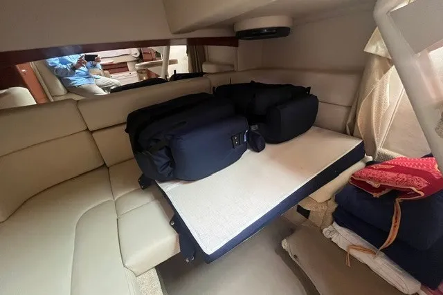 Slide: The Image of Interior cabin of a 2004 Sea Ray Sundancer 320 with seating and luggage. - 30