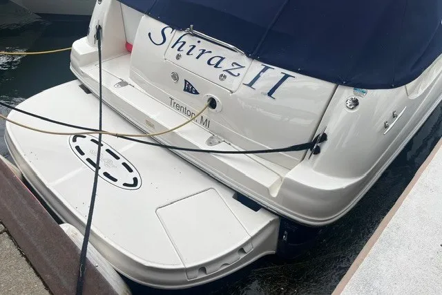 Slide: The Image of 2004 Sea Ray Sundancer 320 docked, rear view with "Shiraz II" name visible. - 3