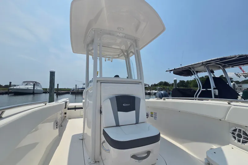 Slide: The Image of 2022 Robalo R230 Center Console boat docked at marina under clear blue sky. - 8