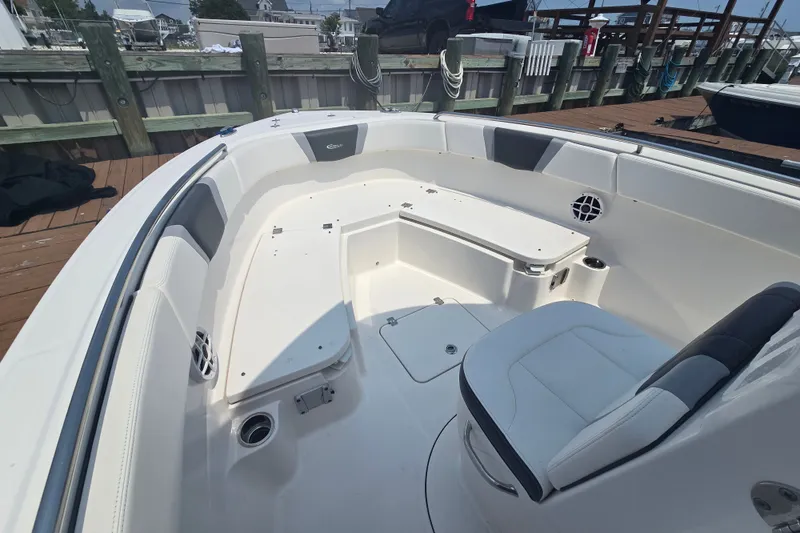 Slide: The Image of 2022 Robalo R230 Center Console boat interior with seating and storage compartments. - 9