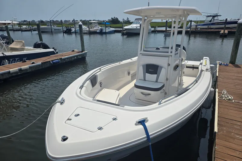 Slide: The Image of 2022 Robalo R230 Center Console boat docked in a marina. - 6