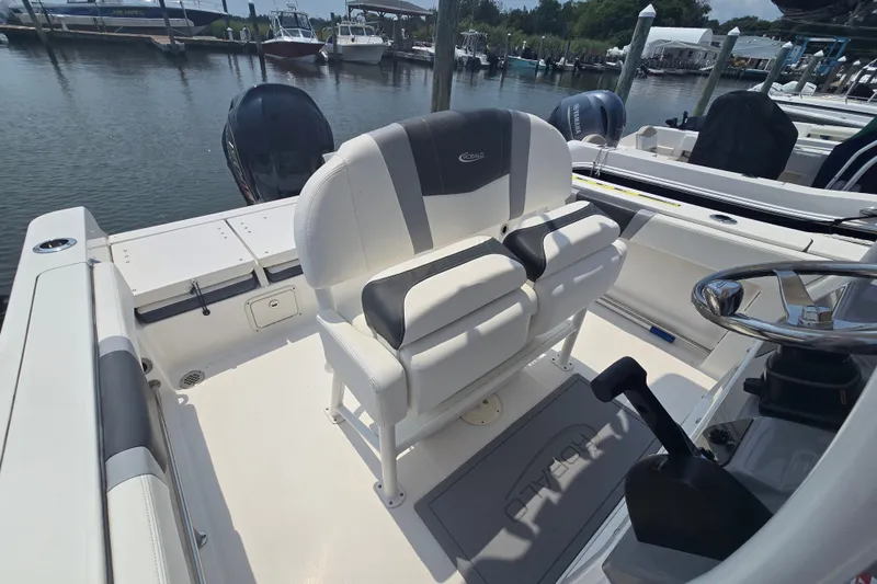 Slide: The Image of 2022 Robalo R230 Center Console boat interior with dual seating and steering wheel. - 11
