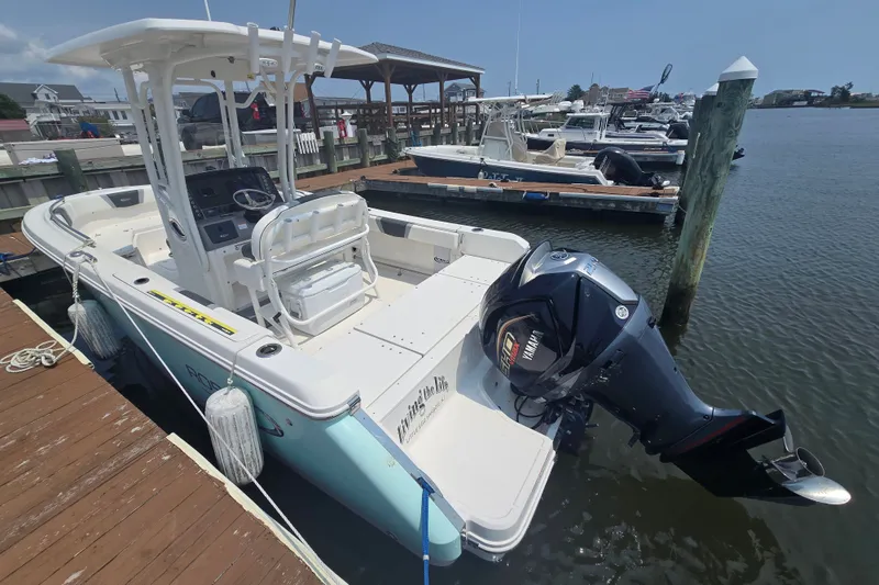 Slide: The Image of 2022 Robalo R230 Center Console boat docked with Yamaha outboard motor. - 19