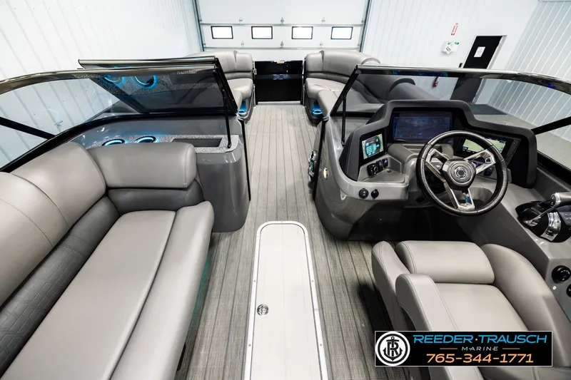Slide: The Image of Interior of a 2021 Avalon EXCALIBUR boat with modern dashboard and seating. - 17