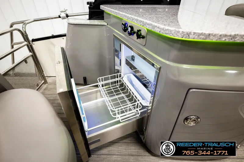 Slide: The Image of 2021 Avalon EXCALIBUR boat interior with open refrigerator and modern countertop design. - 27