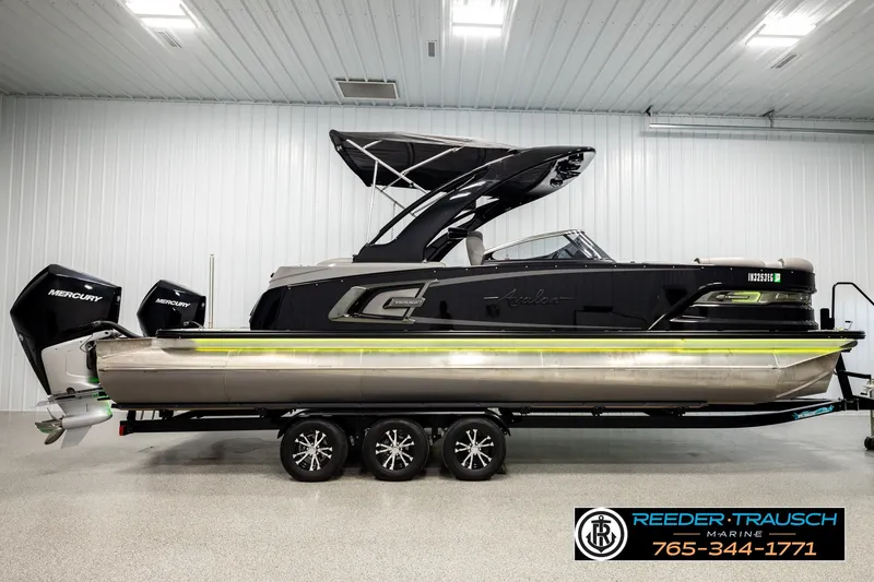 Slide: The Image of 2021 Avalon EXCALIBUR pontoon boat with dual Mercury engines in a showroom. - 5