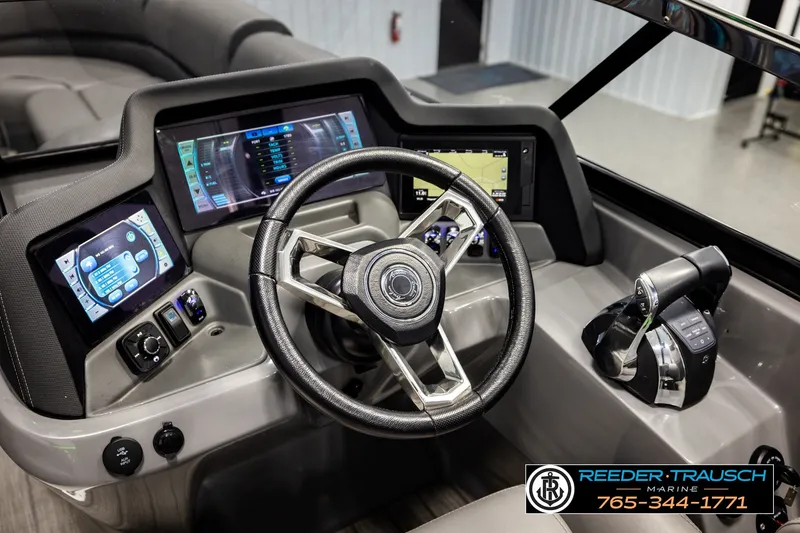 Slide: The Image of Steering console of 2021 Avalon EXCALIBUR boat with advanced digital displays and controls. - 31
