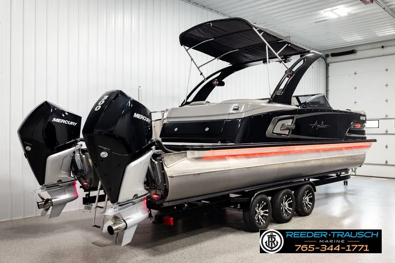 Slide: The Image of 2021 Avalon EXCALIBUR boat with dual Mercury engines in a showroom. - 6