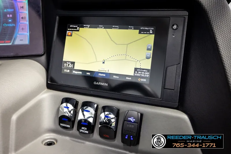 Slide: The Image of Garmin navigation system in 2021 Avalon EXCALIBUR boat dashboard with control switches. - 37