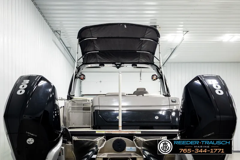 Slide: The Image of 2021 Avalon EXCALIBUR boat with dual 300 horsepower Mercury engines in a storage facility. - 7