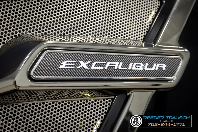 Slide: The Image of Close-up of 2021 Avalon EXCALIBUR logo on metallic mesh background. - 58
