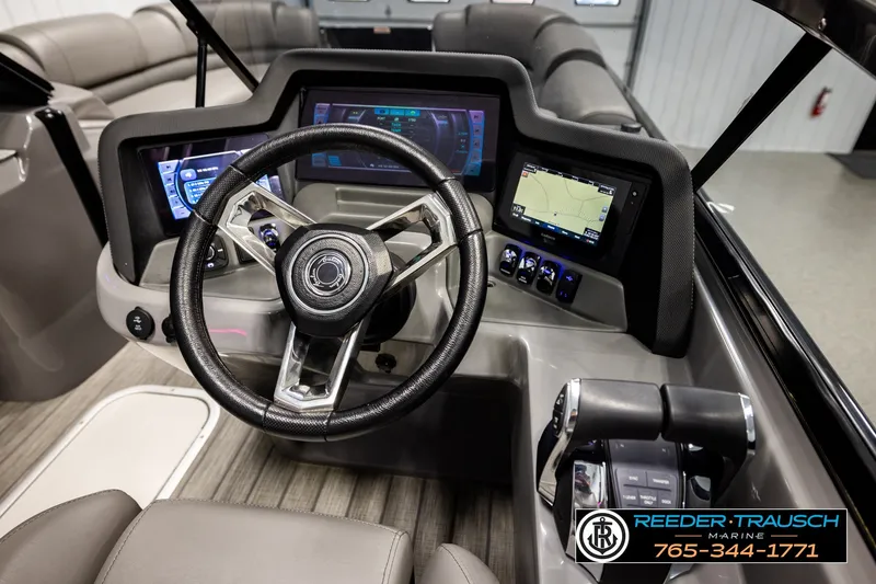 Slide: The Image of 2021 Avalon EXCALIBUR boat dashboard with steering wheel, digital displays, and controls. - 30