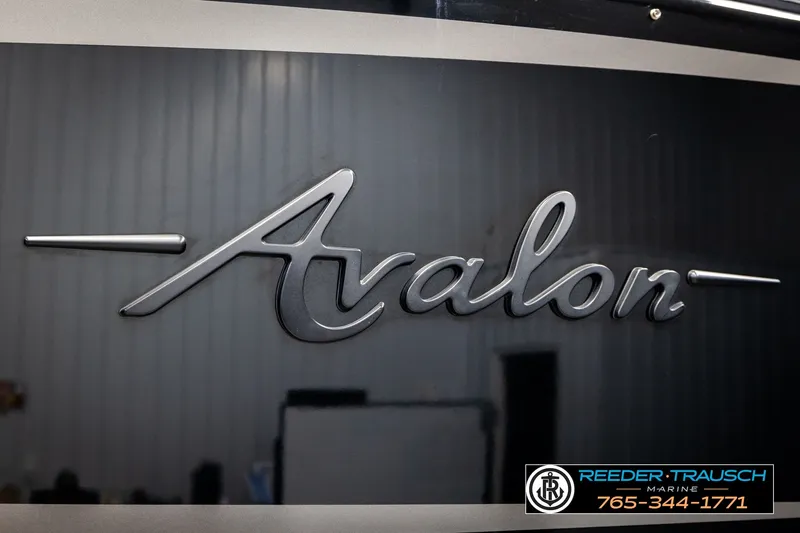 Slide: The Image of 2021 Avalon EXCALIBUR logo on sleek black surface, Reeder Trausch Marine contact details visible. - 57