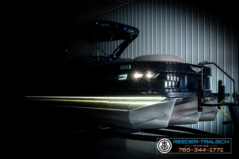 Slide: The Image of 2021 Avalon EXCALIBUR pontoon boat in a dimly lit storage facility. - 4