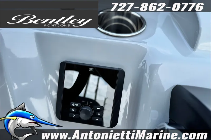 Slide: The Image of 2027 Bentley Pontoons Bolt 223 dashboard with JBL audio system and cup holder. - 16