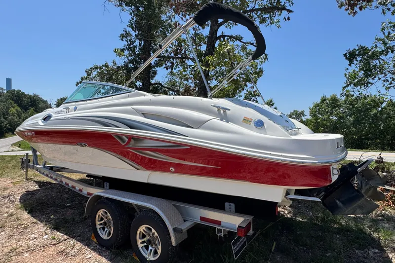 Slide: The Image of 2003 Searay 270 Sundeck boat on trailer, red and white design, parked outdoors. - 5
