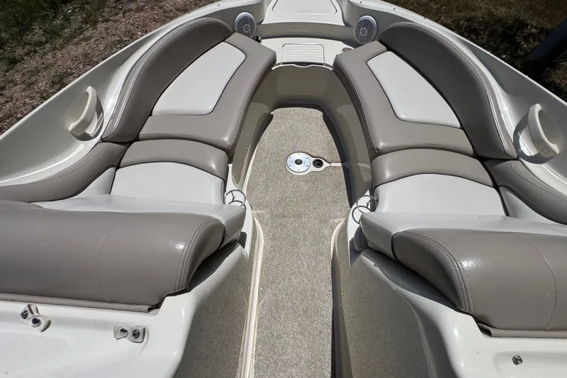 Slide: The Image of 2003 Searay 270 Sundeck interior with beige seating and carpeted floor. - 23
