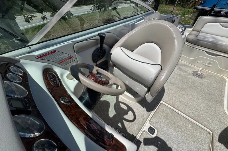 Slide: The Image of Interior view of 2003 Searay 270 Sundeck boat cockpit with steering wheel and controls. - 11