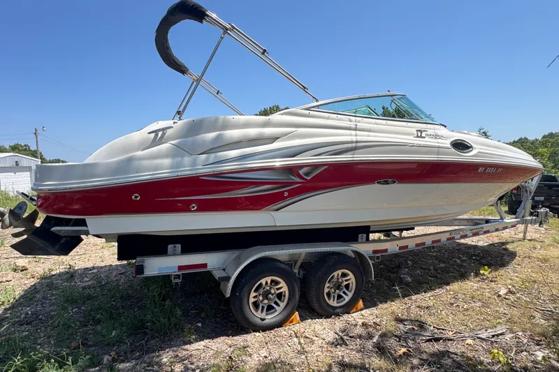 Slide: The Image of 2003 Searay 270 Sundeck boat on trailer, red and white design, sunny day. - 4