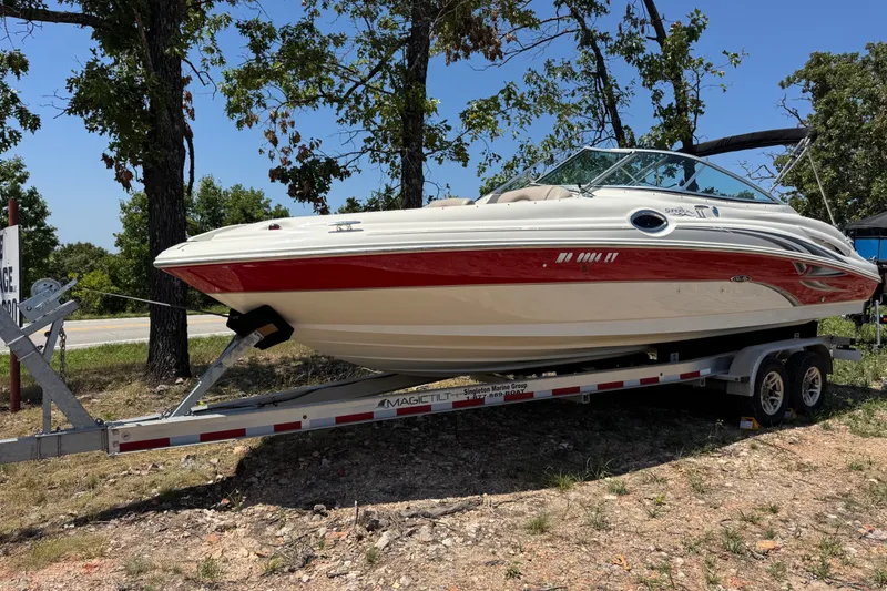 Slide: The Image of 2003 Searay 270 Sundeck boat on trailer, parked outdoors near trees. - 1