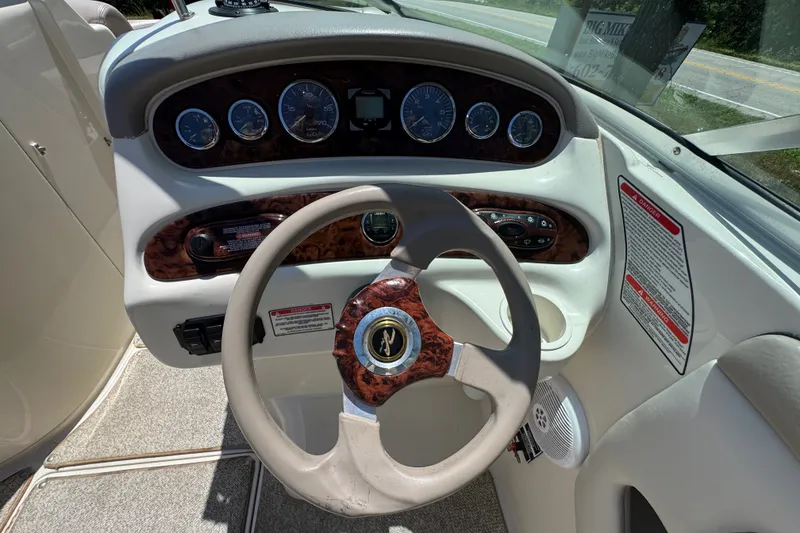 Slide: The Image of Steering wheel and dashboard of a 2003 Searay 270 Sundeck boat. - 12