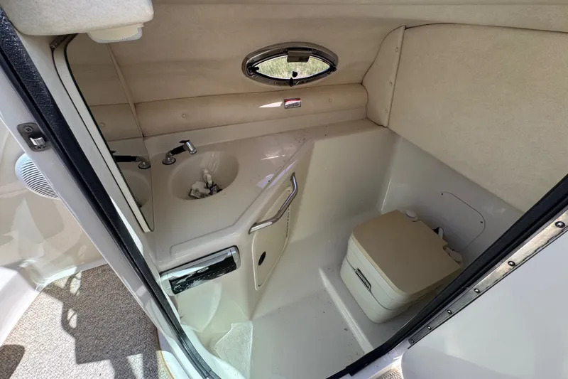Slide: The Image of Interior of 2003 Searay 270 Sundeck boat bathroom with sink and portable toilet. - 19
