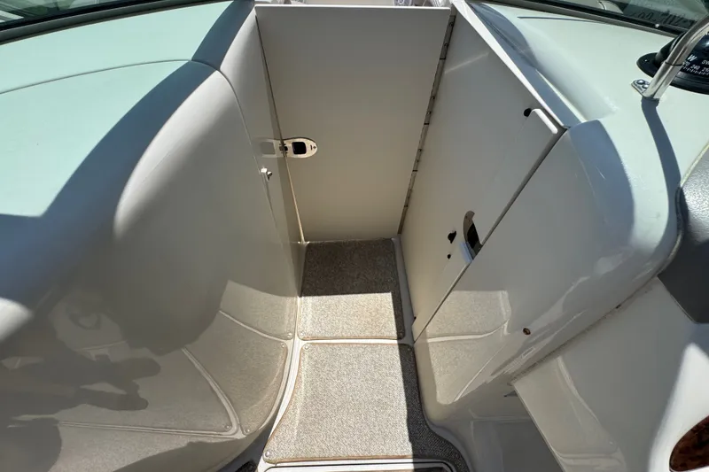 Slide: The Image of 2003 Searay 270 Sundeck interior with carpeted flooring and storage compartment. - 21
