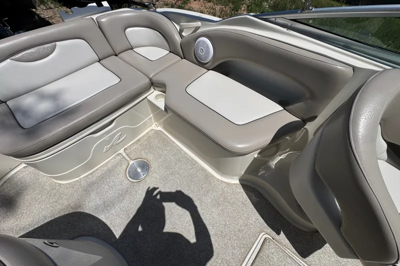 Slide: The Image of 2003 Searay 270 Sundeck interior with beige seating and speaker detail. - 14